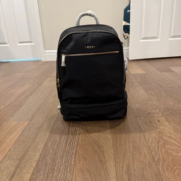 Tumi Backpack in Black with Gold Details and multiple components